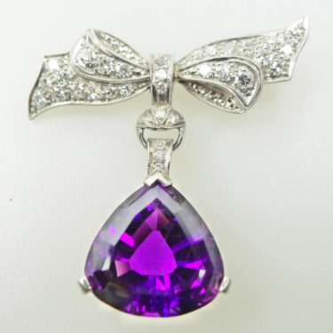 bow style diamond pin brooch with drop pear shaped amethyst